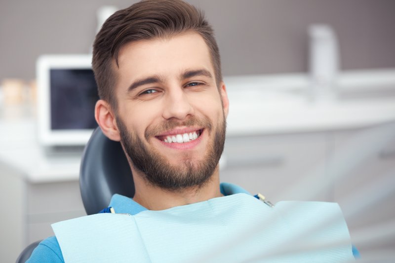 Man smiling in dental chair after root canal treatment