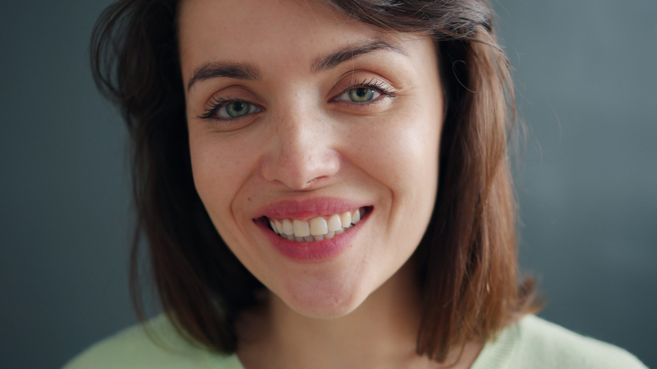 Woman smiling with natural-looking tooth-colored fillings
